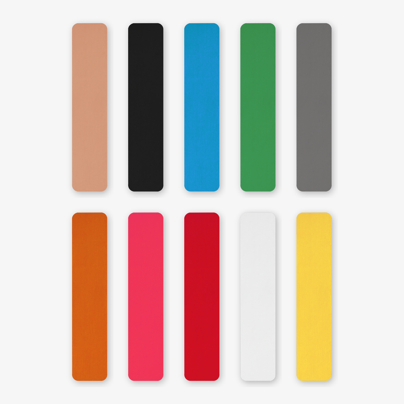 Ten pre-cut kinesiology tape strips laid flat in beige, black, blue, green, grey, orange, pink, red, white and yellow, each 5cm by 25cm with rounded corners